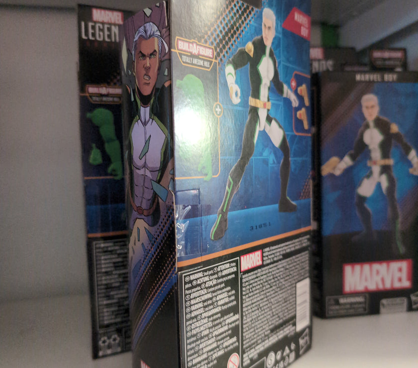Hasbro Marvel Legends Marvel Boy action figure packaging displayed on a store shelf with artwork and accessories visible
