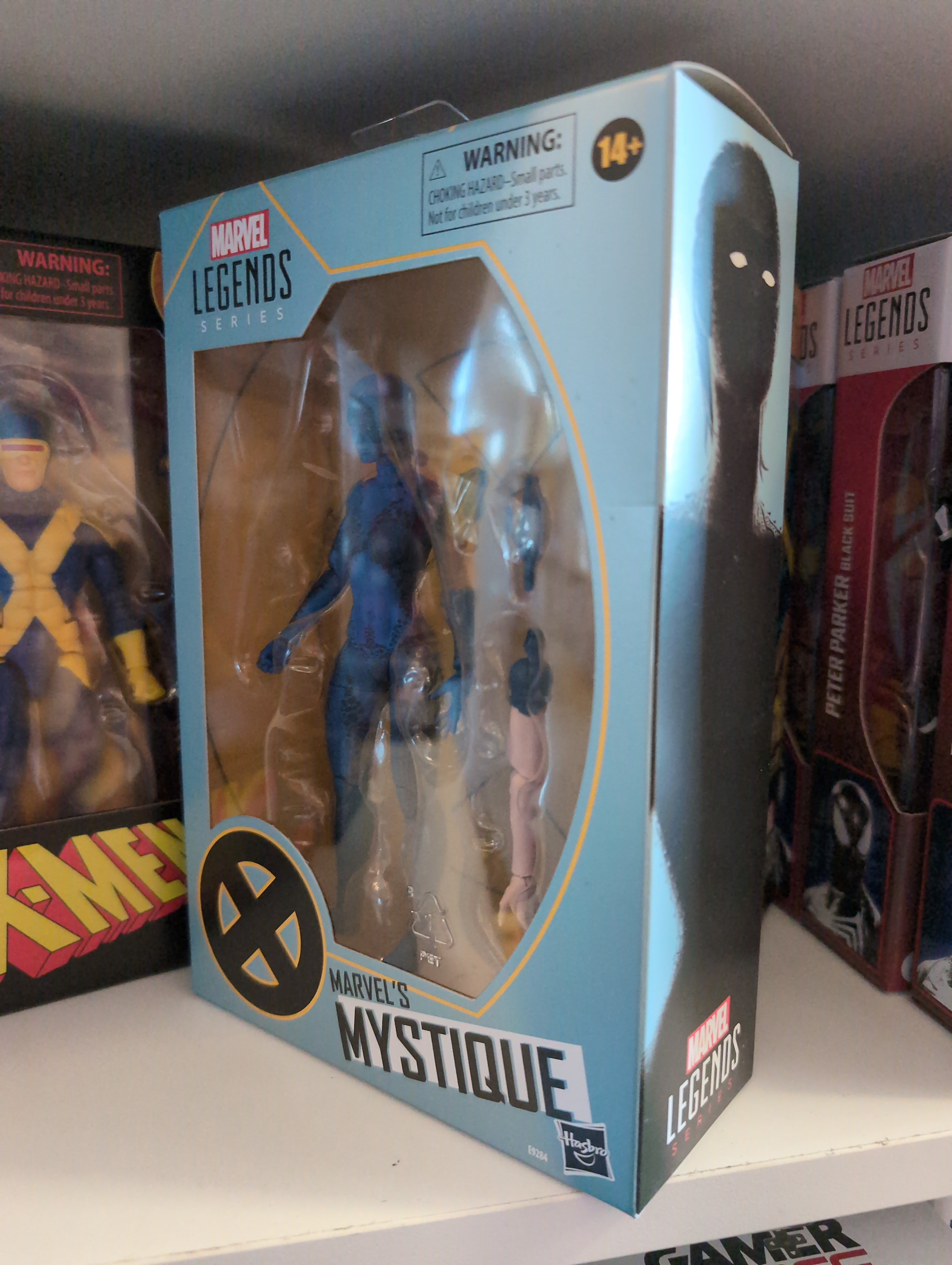 Hasbro Marvel Legends Mystique 6-inch action figure from X-Men series in collector packaging on display shelf