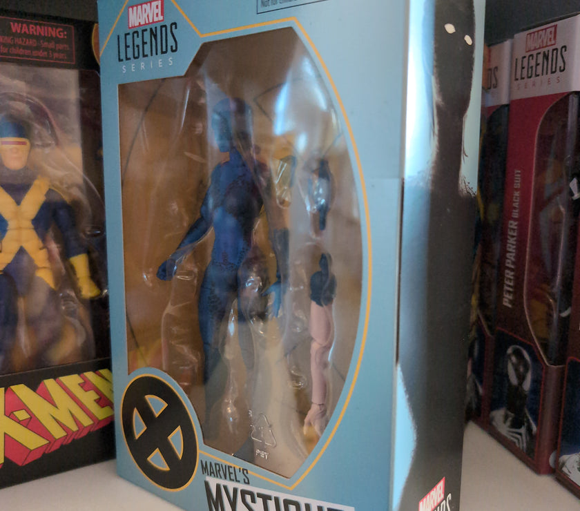 Hasbro Marvel Legends Mystique 6-inch action figure from X-Men series in collector packaging on display shelf