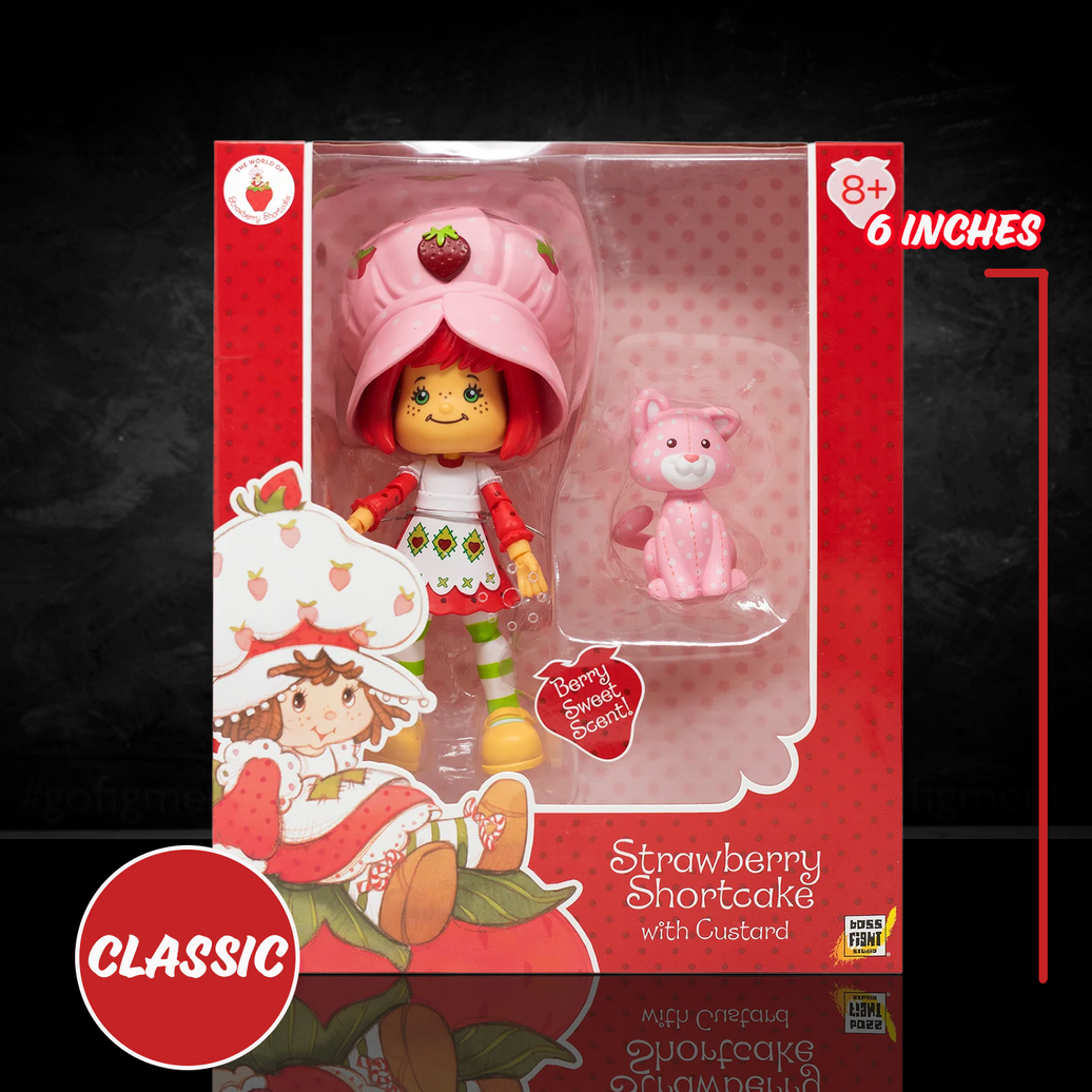 Strawberry Shortcake doll wearing pink hat with strawberry detail and a small pink cat figure in red polka dot packaging